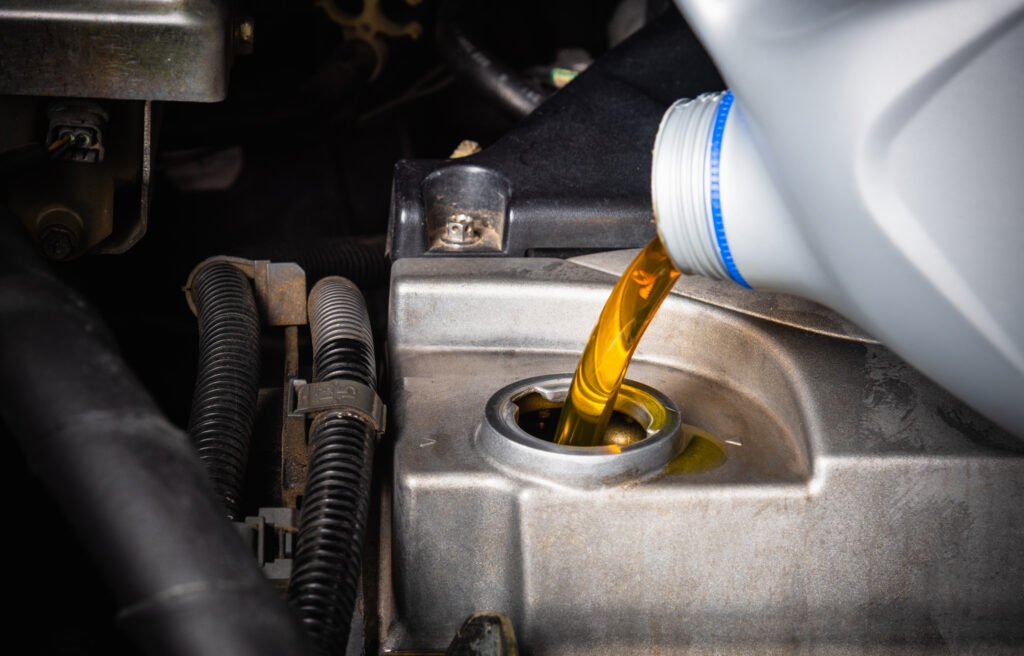 worker pouring the engine oil